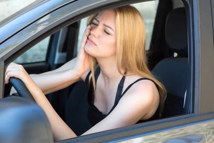 female car driver with toothache